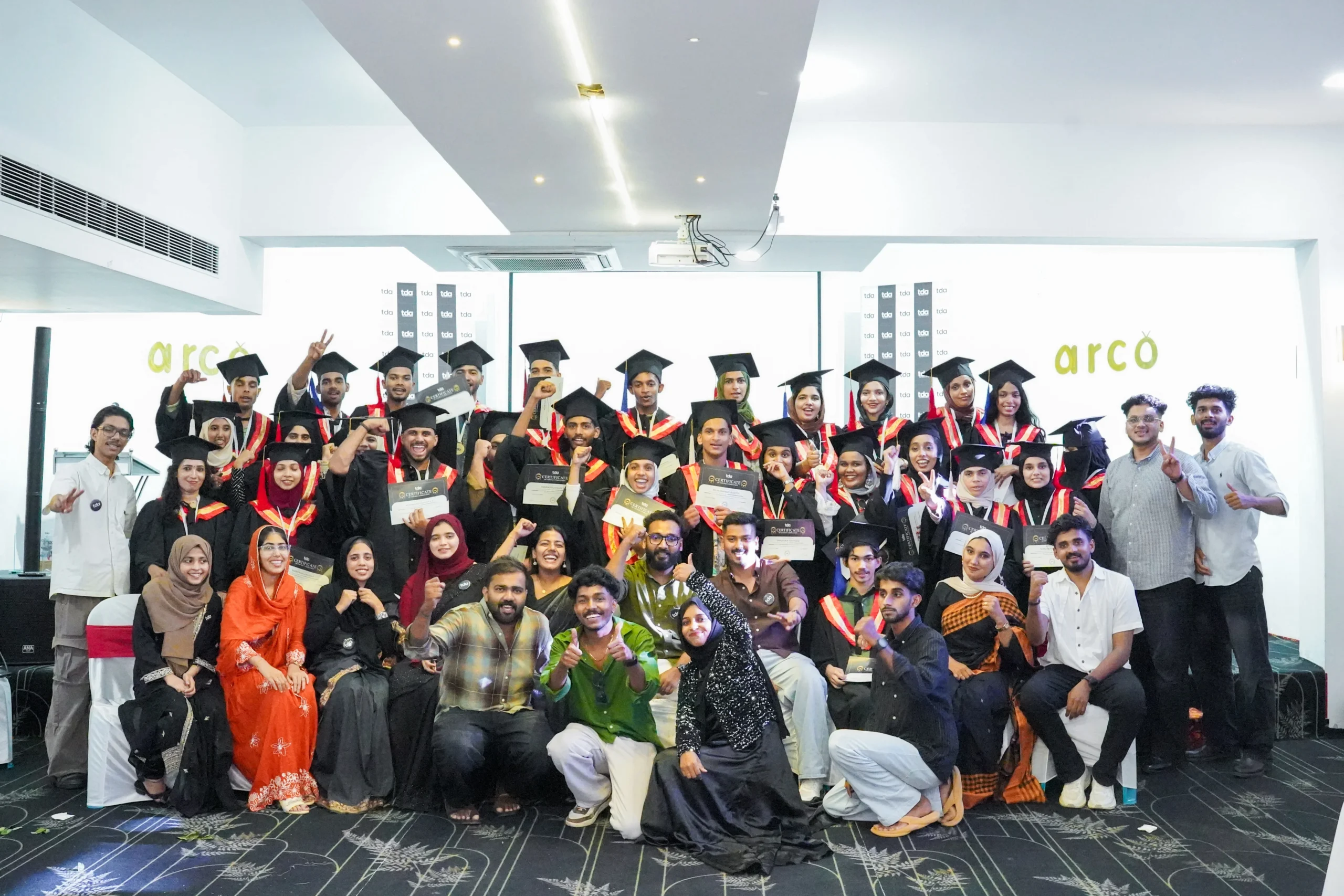 Tag4 Digital Academy graduation ceremony with students in caps and gowns
